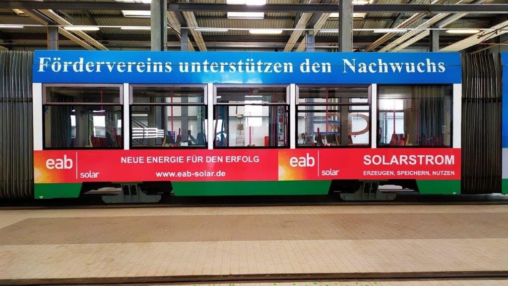 Straßenbahn mit eab solar Werbung und Logo des 1. FC Magdeburg Nachwuchs
